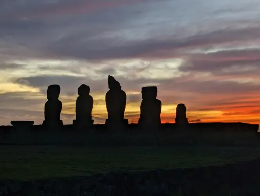 Photo of moai statues at sunset